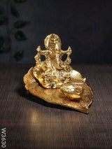 White Metal Ganesha In Pipal Leaf With Diya Gold Finish - W3630 Diyas